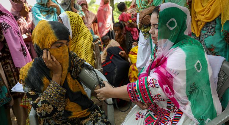 A health worker performs blood pressure tests on patients in a rural area in India. A health worker performs blood pressure tests on patients in a rural area in India.