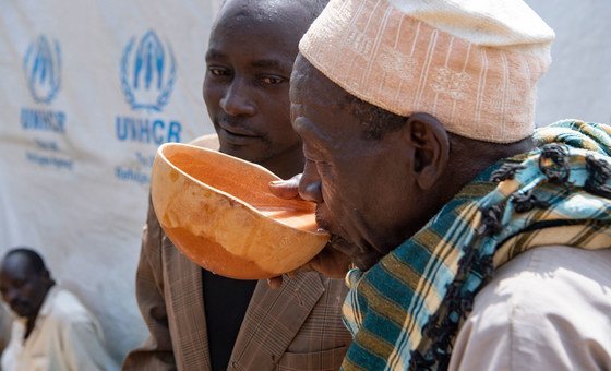 Men in the village of Zamai in the Far North Region of Cameroon, drink local beer brewed by the former terrorist hostage, Wala Matari.