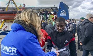 Rescued refugees and migrants disembark from a ship commissioned by a German non-governmental organization in the Sicilian port of Catania in January 2019.