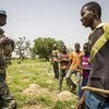 A United Nations peacekeeper in Mali interacts with children in the Mopti region of the West African country. (July 2019)