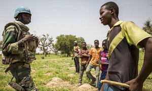 A United Nations peacekeeper in Mali interacts with children in the Mopti region of the West African country. (July 2019)