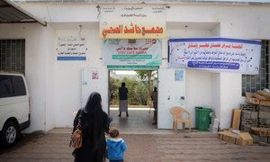 A woman brings a child to a vaccination site in Aden, Yemen during a UNICEF-supported Measles and Rubella vaccination campaign on 11 February 2019. 