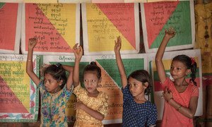 Children raise their hands to answer a question in class at a UNICEF learning space in Cox's Bazar, Bangladesh. (8 July 2019).