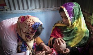 A volunteer at the Primary Health Centre in on of Cox's Bazaar's vast refugee camps inoculates the baby of an 18-year-old mother, Bangladesh 2019. 