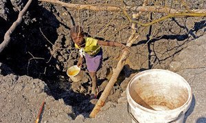 A 10-year-old child helps her family look for water in southern Angola. Failed rains in the first three months of 2019 decimated crops and livestock, affecting about 2.3 million people. 
