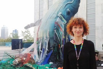 Sandra Schöttner, Oceans Campaigner and Global Project Leader at Greenpeace, stands at UN Headquarters in New York in front of an art installation depicting the need to address plastic pollution in the world's oceans.