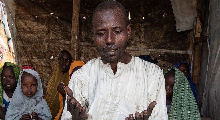 Mohammed Lawan Goni, a Nigerian refugee living in Cameroon, prays with his family in Minawao camp.  (4 February 2019)