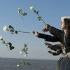 Visitors throw white flowers into Rio de la Plata as a symbol of respect at the Parque de la Memoria during a memorial in Buenos Aires to the victims of Argentina's so-called "Dirty War". (2016)