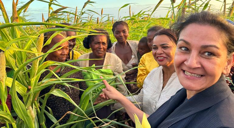 The UN Climate Crisis Coordinator Reena Ghelani (right) talks with farmers in a field of millet in the south of Madagascar.