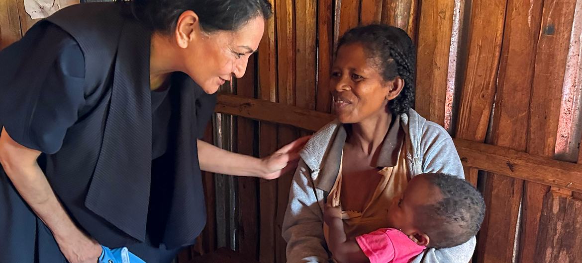 The UN Climate Crisis Coordinator Reena Ghelani (left)interacts with a mother and child in the south of Madagascar.