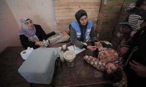 An UNRWA staff member provides medical care to a child in Gaza. (file)