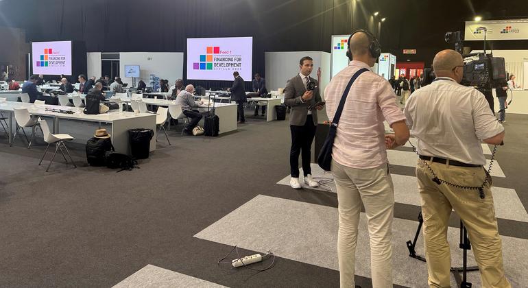 Journalists work in the media centre of the FFD4 conference in Sevilla, Spain.