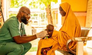 A baby is treated at a health centre in Nigeria.