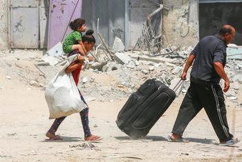 A family moves possessions amidst the rubble in Gaza (file).