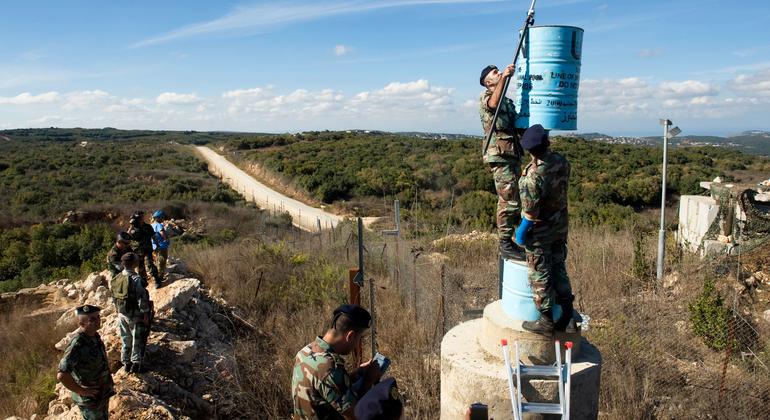 UNIFIL and Lebanese officers serve one of the blue barrels, which identify the Blue Line, in southern Lebanon. (document)