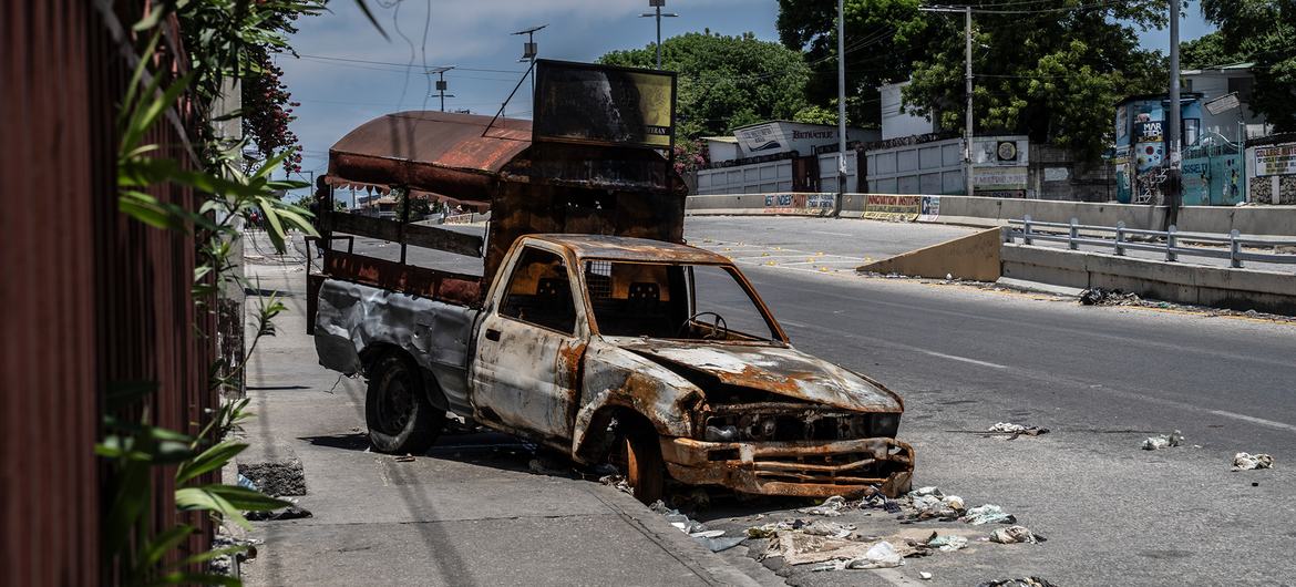 A burnt-out vehicle litters the side of a road in a neighbourhood in the Haitian capital, Port-au-Prince.