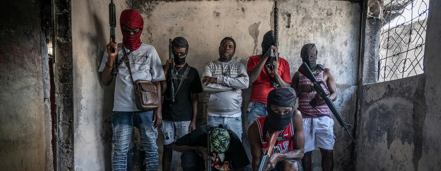 Gang members brandish their weapons in the Delmas 3 neighbourhood of the Haitian capital, Port-au-Prince. Gang members brandish their weapons in the Delmas 3 neighbourhood of the Haitian capital, Port-au-Prince.