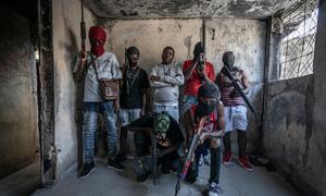 Gang members brandish their weapons in the Delmas 3 neighbourhood of the Haitian capital, Port-au-Prince.