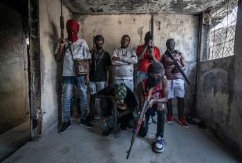 Gang members brandish their weapons in the Delmas 3 neighbourhood of the Haitian capital, Port-au-Prince.