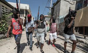 Gang members walk through a neighbourhood in Port-au-Prince.