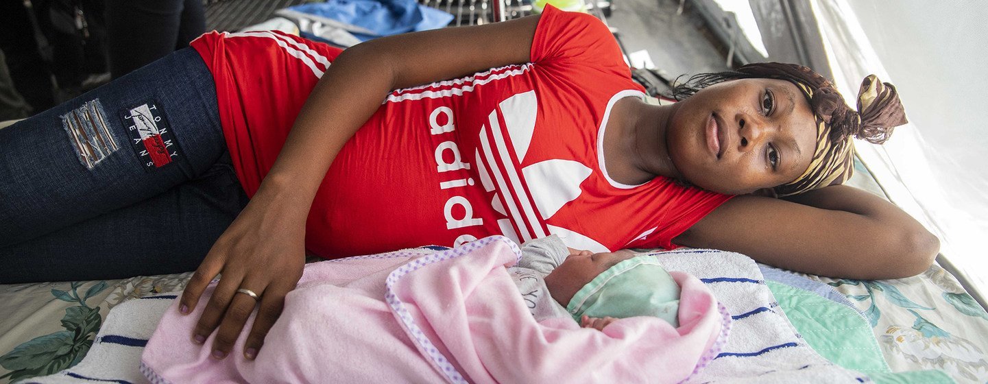 Désir Murielle and her new-born baby boy, Yves, rest in a tented maternity ward.