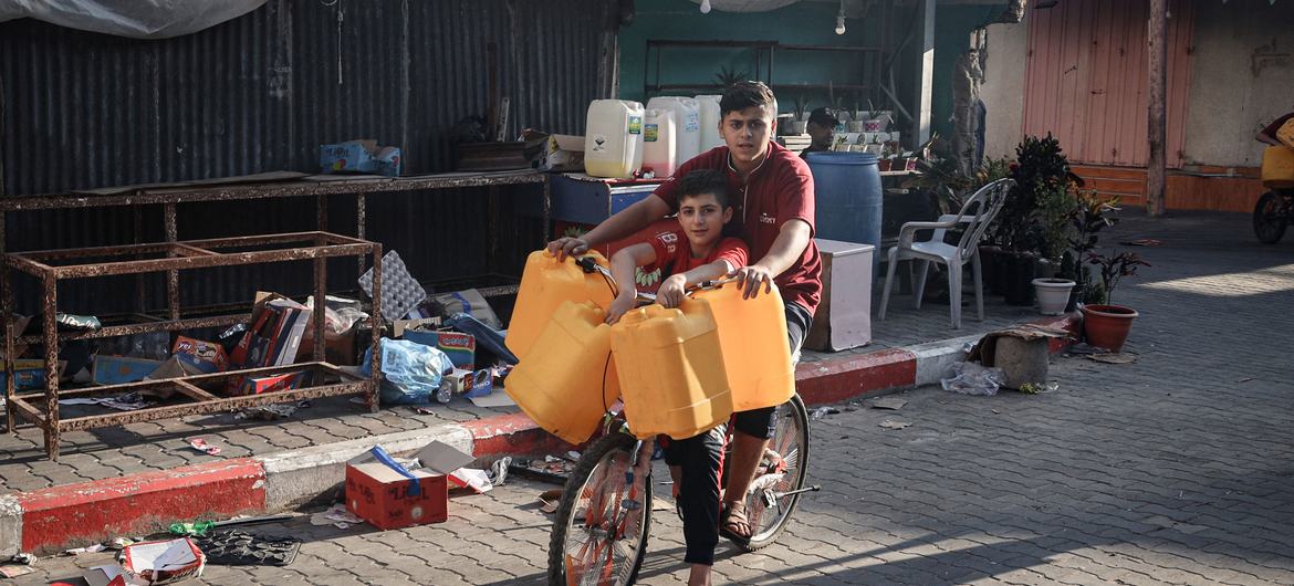 Children collect water in Rafah city, in the southern Gaza Strip.