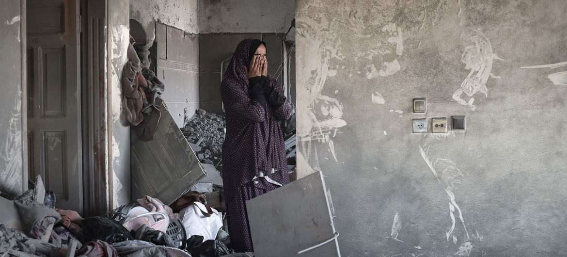 A woman visists her bombed out house in Rafah city in the southern Gaza Strip.