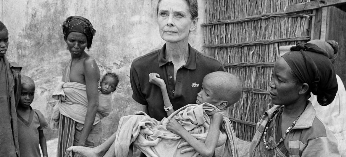 Audrey Hepburn, one of UNICEF’s most beloved Goodwill Ambassadors, holds a child at a feeding centre in Baidoa, Somalia, in 1992.