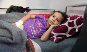 A young boy recovers in hospital in Gaza after the shelter he was living in with his family was bombed.