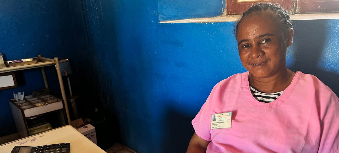 Jeanne Bernadine Rasoanirina sits at her desk with her newly delivered maternity kit.