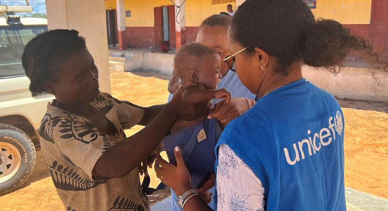 A baby is weighed at the primary health care centre in Behara.