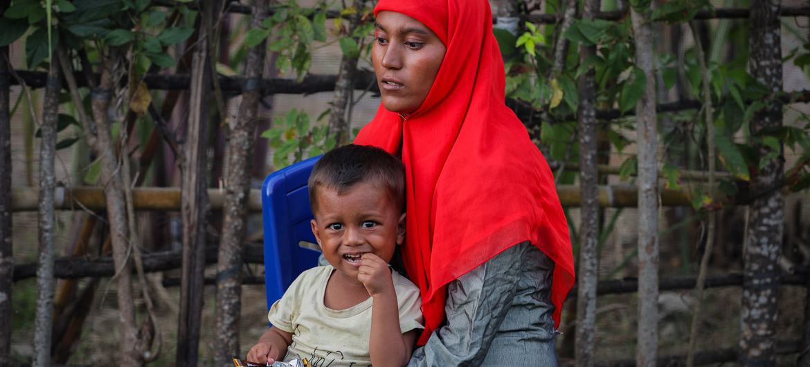 A Rohingya refugee rests with a child after being rescued at sea off the coast of Indonesia. A Rohingya refugee rests with a child after being rescued at sea off the coast of Indonesia.