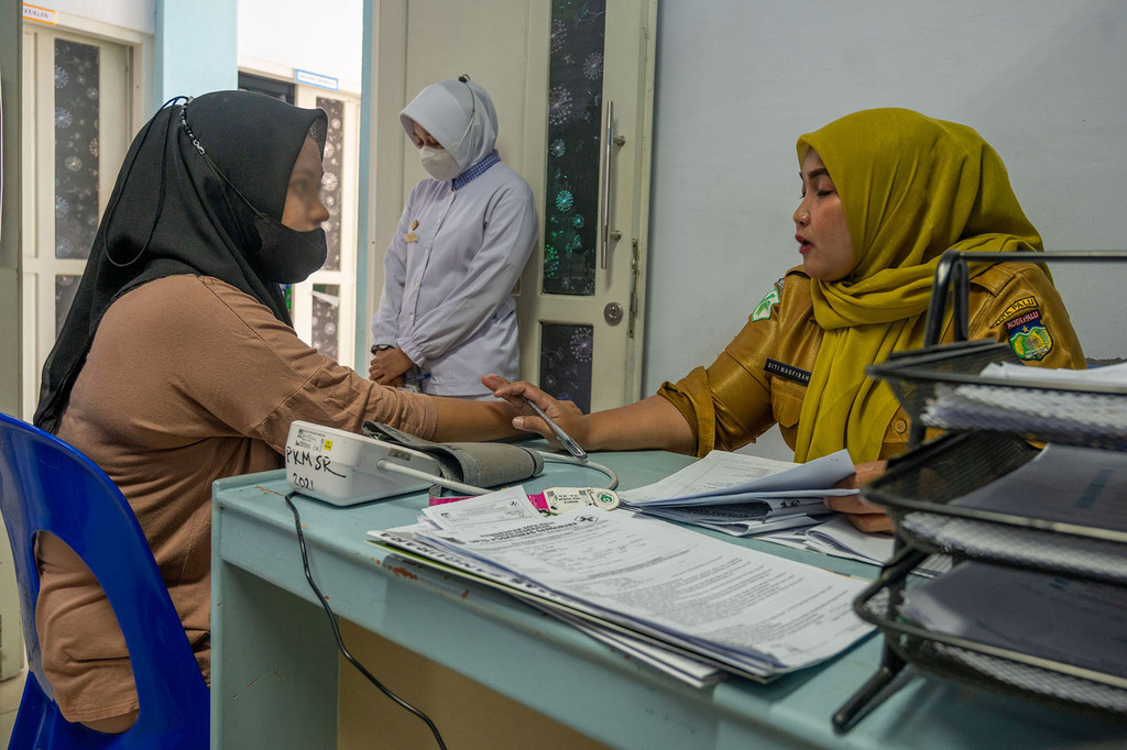 A victim of gender-based violence is counselled at the Sanguara Health Centre in Palu. 