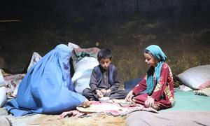 A family in a village in Badakhshan Province, Afghanistan eat food received from the UN.