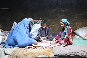 A family in a village in Badakhshan Province, Afghanistan eat food received from the UN.