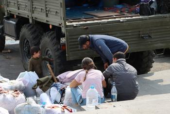People fleeing Karabakh rest and receive humanitarian aid in Goris, Armenia.