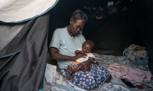 Many people in Haiti displaced by violence, like this mother and baby, struggle to find enough to eat.