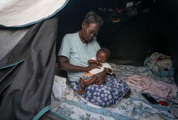 Many people in Haiti displaced by violence, like this mother and baby, struggle to find enough to eat.