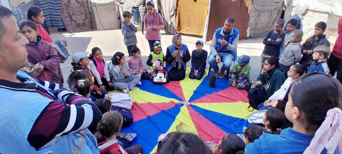 Children in Gaza receive support from UNRWA staff members. In his priorities speech the UN chief paid tribute to the agency as the backbone of the humanitarian response in Gaza.