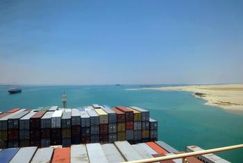 A container ship passes through the Suez Canal.