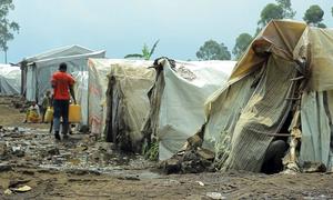 A man carries water in a camp for displaced people in Goma, in the eastern Democratic Republic of the Congo.