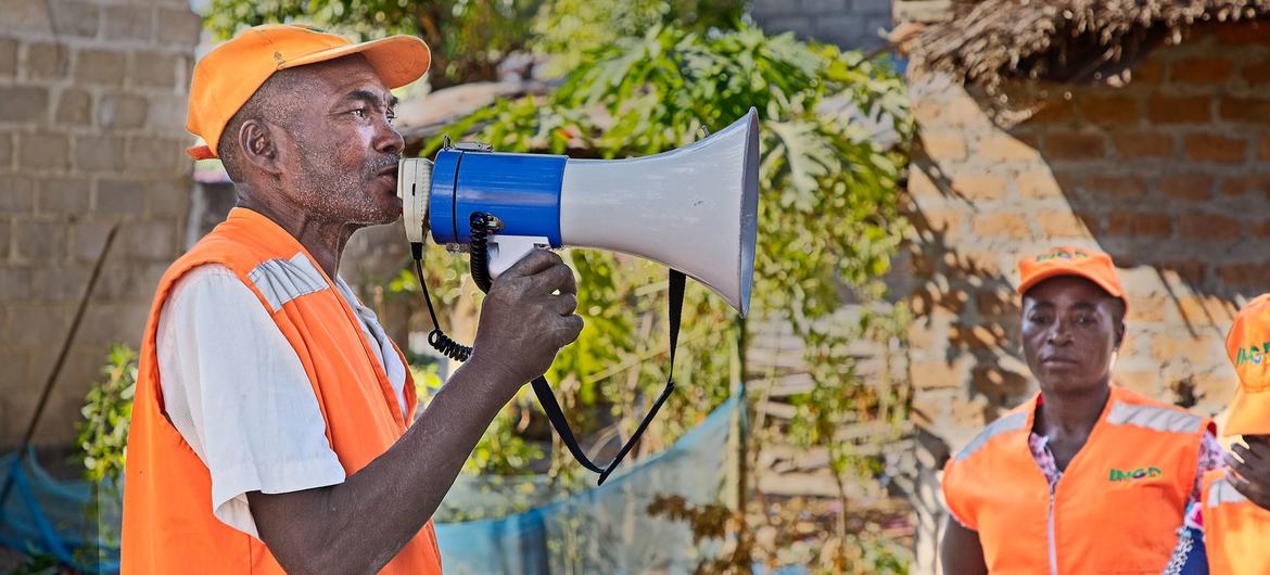 A local disaster risk reduction committee member communicates early warning messages to residents of a village on the banks of the Licungo River in Zambezia Province, Mozambique. A local disaster risk reduction committee member communicates early warning messages to residents of a village on the banks of the Licungo River in Zambezia Province, Mozambique.