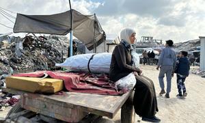 A woman in Gaza waits to return home.