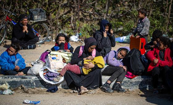 Displaced Palestinian families from Khan Younis wait on the roadside for detained husbands and fathers. 
