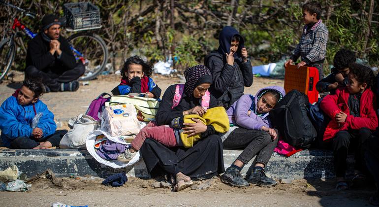 Displaced Palestinian families from Khan Younis wait on the roadside for detained husbands and fathers. 