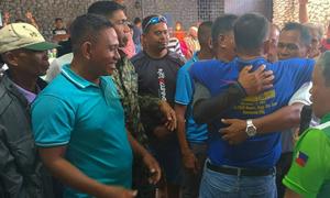 Families embrace as they agree to end a decades-long feud.