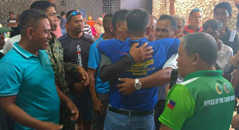 Families embrace as they agree to end a decades-long feud.