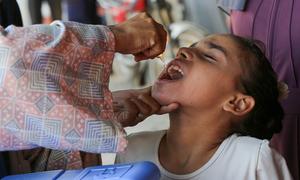 A polio vaccine is administered to a child in Gaza, a campaign supported by WHO.