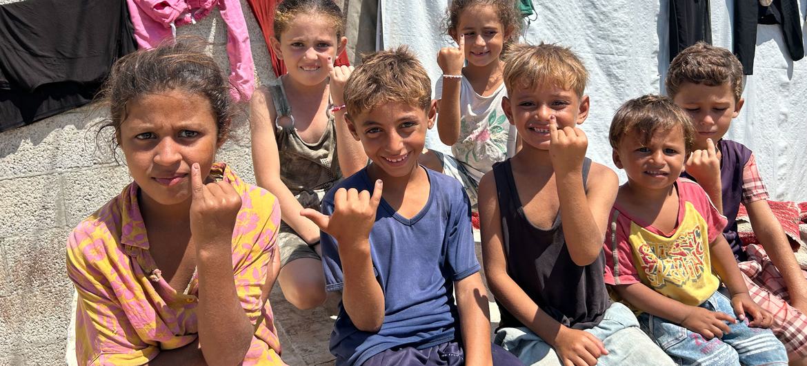 Young children in Gaza show their inked fingers indicating they have been vaccinated against polio.