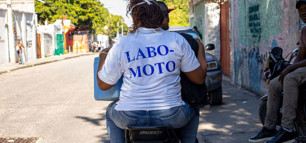 A 'labo moto' health worker travels by motorbike to visit a patient. A 'labo moto' health worker travels by motorbike to visit a patient.